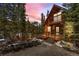 Inviting cabin-style home with a cozy deck, surrounded by lush trees and a mountain view at 563 Brook Dr, Idaho Springs, CO 80452