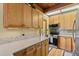 Bright kitchen with wood cabinets, stainless steel appliances, and stone countertops at 563 Brook Dr, Idaho Springs, CO 80452