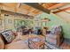 Bright living room with wood beams, comfortable seating, and a rustic fireplace at 563 Brook Dr, Idaho Springs, CO 80452