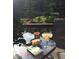 Relaxing patio scene with scenic views, featuring a margarita and snack, plus book at 563 Brook Dr, Idaho Springs, CO 80452