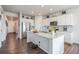 Modern kitchen with white cabinets, granite countertops, and stainless steel appliances at 4245 S Nepal Cir, Aurora, CO 80013