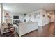 Living room with a corner fireplace, hardwood floors, and ample natural light at 4245 S Nepal Cir, Aurora, CO 80013