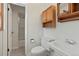 Cozy bathroom featuring tiled floors, vanity, toilet, and a doorway leading to the shower area at 8897 Baseline Rd, Lafayette, CO 80026