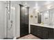 Bathroom featuring marble shower, double vanity with white countertop and dark cabinets and a storage cabinet at 1438 Little Raven St # 407, Denver, CO 80202