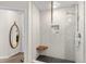 Bathroom shower featuring a wooden corner seat and a marble tiled wall and black tiled floor at 1438 Little Raven St # 407, Denver, CO 80202