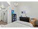 Bright bedroom features modern chandelier lighting, accent chair and ample display shelving at 1438 Little Raven St # 407, Denver, CO 80202