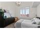 Bedroom with a light grey comforter, dark dresser, woven chair, and a chandelier light fixture at 1438 Little Raven St # 407, Denver, CO 80202