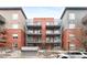 Apartment building featuring brick facade and multiple balconies on each unit at 1438 Little Raven St # 407, Denver, CO 80202