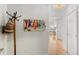 Bright hallway with hardwood floors, coat rack, and decorative artwork at 1438 Little Raven St # 407, Denver, CO 80202