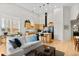 Spacious living room featuring hardwood floors, an island, and a kitchen at 1438 Little Raven St # 407, Denver, CO 80202
