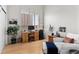 Living room with a desk, white sofa, and large windows for ample sunlight at 1438 Little Raven St # 407, Denver, CO 80202