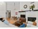 Bright living room featuring modern furniture, hardwood floors, and a fireplace at 1438 Little Raven St # 407, Denver, CO 80202