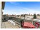 Condo patio with a table, chairs, and a beautiful scenic overlook and skyline view at 1438 Little Raven St # 407, Denver, CO 80202