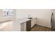 Modern kitchen island with white cabinets and stainless steel dishwasher at 14586 W 91St Ave # B, Arvada, CO 80005