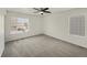 Simple bedroom with grey carpet and large window at 18986 E 51St Pl, Denver, CO 80249