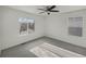 Simple bedroom with a ceiling fan and a large window at 18986 E 51St Pl, Denver, CO 80249