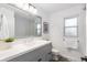 Bright bathroom featuring a large mirror, updated fixtures, and a stylish vanity with ample storage space at 6764 Hillridge Pl, Parker, CO 80134