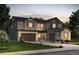 Charming two-story home featuring a stone-accented facade, a two-car garage, and professional landscaping at 8484 Orchard City Dr, Littleton, CO 80125