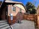 Brick home with a spacious backyard, wooden fence, and a patio at 1325 Clermont St, Denver, CO 80220