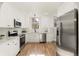 Modern white kitchen with stainless steel appliances at 1325 Clermont St, Denver, CO 80220