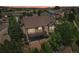 An aerial view of the home showcasing mature landscaping, a patio, and a deck at 15947 Bridle Ridge Dr, Monument, CO 80132