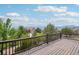 Spacious back deck with scenic views of trees, neighboring homes, and distant mountains at 15947 Bridle Ridge Dr, Monument, CO 80132