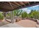 An outdoor patio area featuring patterned pavers, brick planters, and a view of the yard at 15947 Bridle Ridge Dr, Monument, CO 80132