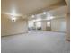 Large finished basement with neutral walls, carpeting, and comfortable seating area with natural light at 15947 Bridle Ridge Dr, Monument, CO 80132