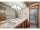 Bathroom features double sink vanity, tile countertop, modern lighting and tiled walk-in shower at 15947 Bridle Ridge Dr, Monument, CO 80132