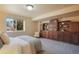 Bedroom with carpet, built-in shelves and cabinets and a window with a view of the outdoors at 15947 Bridle Ridge Dr, Monument, CO 80132