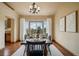 Well-lit dining room features hardwood floors and large window with backyard view at 15947 Bridle Ridge Dr, Monument, CO 80132