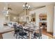 Open-concept dining area with dark wood table and modern chandelier lighting at 15947 Bridle Ridge Dr, Monument, CO 80132