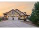 Attractive home exterior with stone accents, mature landscaping, and two-car garage at 15947 Bridle Ridge Dr, Monument, CO 80132