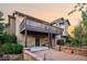 Exterior view of a two-story home featuring a deck, a patio, and mature landscaping at 15947 Bridle Ridge Dr, Monument, CO 80132