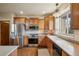 Spacious kitchen features stainless steel appliances, wood cabinets, and a bright window over the sink at 15947 Bridle Ridge Dr, Monument, CO 80132