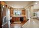 Bright kitchen with stainless steel appliances, wood cabinetry, and a window overlooking the landscape at 15947 Bridle Ridge Dr, Monument, CO 80132