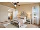 Bright main bedroom with ceiling fan, ensuite access, plush carpet, and plentiful natural light at 15947 Bridle Ridge Dr, Monument, CO 80132