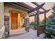 Charming covered porch with stone columns, wood beams, and scenic views at 15947 Bridle Ridge Dr, Monument, CO 80132