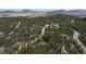 Aerial view of a community nestled amongst the trees, with mountain range in the distance at 5 Ronnie Rd, Golden, CO 80403