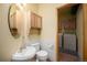 Powder room featuring a pedestal sink, toilet, cabinetry, and washer/dryer in an adjacent room at 5 Ronnie Rd, Golden, CO 80403