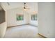 Spacious bedroom featuring vaulted ceilings, two large windows, and neutral carpet at 5 Ronnie Rd, Golden, CO 80403