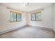 Bedroom featuring two windows with wooded views and neutral carpet at 5 Ronnie Rd, Golden, CO 80403
