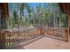 View of the wood deck overlooking a forest landscape, offering a serene outdoor living space at 5 Ronnie Rd, Golden, CO 80403
