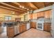 Spacious kitchen with wooden cabinetry, granite countertops, stainless appliances, and wood-beam ceilings at 5 Ronnie Rd, Golden, CO 80403