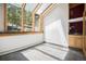 Bright sunroom with walls of windows, tile flooring, and a built-in sink area at 5 Ronnie Rd, Golden, CO 80403