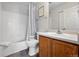 Bathroom featuring tiled shower/tub, wood vanity, and a framed mirror at 10010 E Gunnison Pl # 707, Aurora, CO 80247