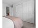 Cozy bedroom featuring plush carpet, white walls, and a spacious closet with sliding doors at 10010 E Gunnison Pl # 707, Aurora, CO 80247