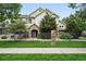Charming home featuring a stone archway entrance, well-maintained landscaping, and black rod iron fencing at 10010 E Gunnison Pl # 707, Aurora, CO 80247