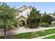 Beautiful home featuring a stone archway entrance surrounded by lush landscaping at 10010 E Gunnison Pl # 707, Aurora, CO 80247