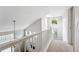 Upstairs hallway with new carpet, vaulted ceilings, modern light fixtures, and large windows at 10010 E Gunnison Pl # 707, Aurora, CO 80247